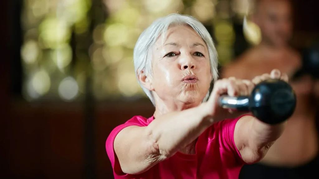 Toning Arms Without the Bulk: Is It Achievable? 1 Woman doing resistance band exercises for toned arms Trowbridge