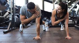 Image of man and woman doing Cardio Trowbridge to tone their arms. 